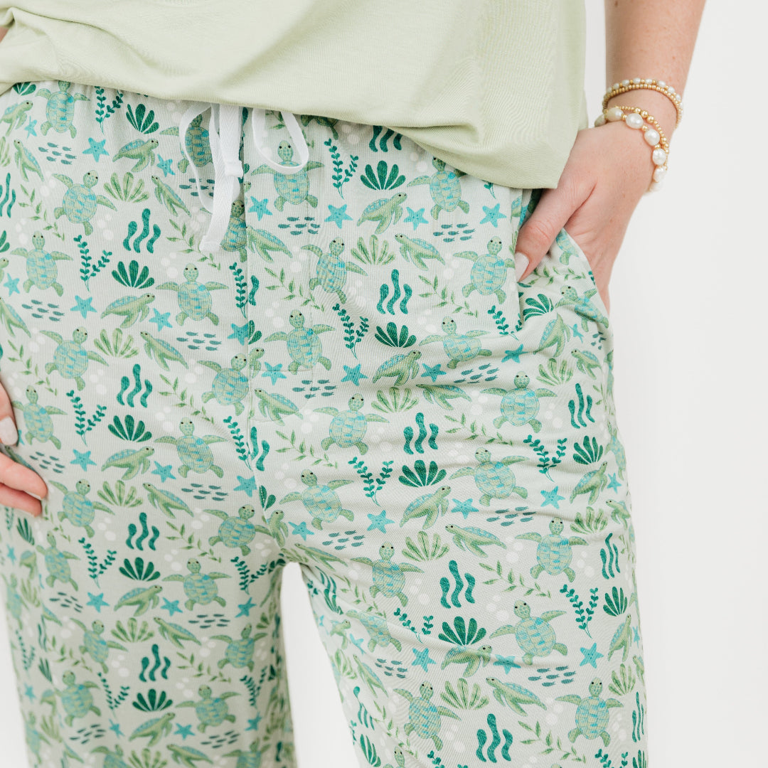 Close up of our Relaxed Long Pants from our Save the Sea Turtle Collection. Featuring\a serene ocean-inspired print with sea turtles and marine life, these ultra-soft bamboo pieces are breathable, moisture-wicking, and eco-friendly. Perfect for lounging or sleeping in sustainable style.