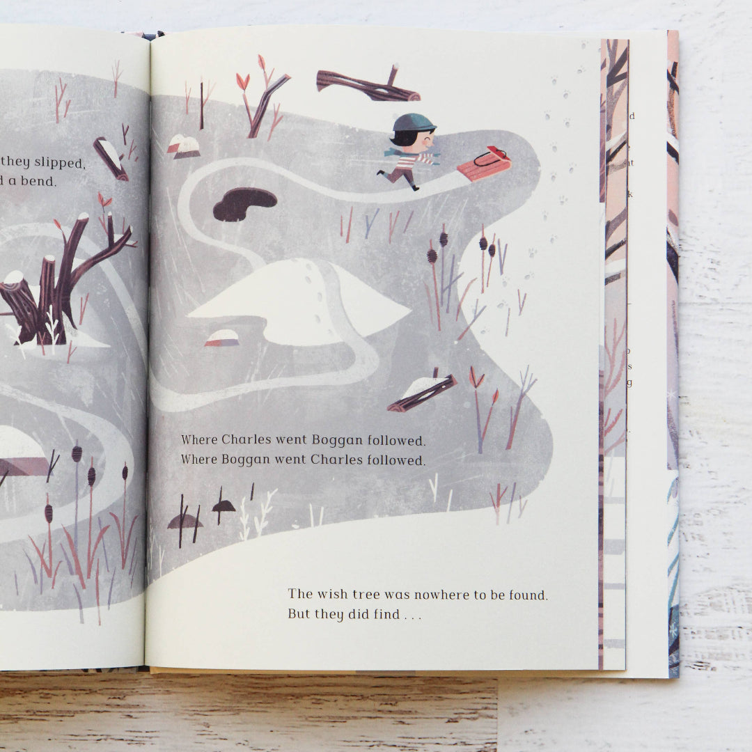 Open book with illustrated pages on a wooden surface