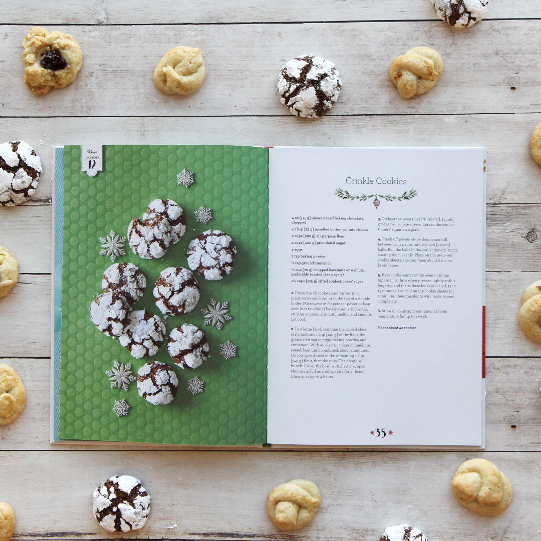 Open cookbook with crinkle cookies on a wooden surface