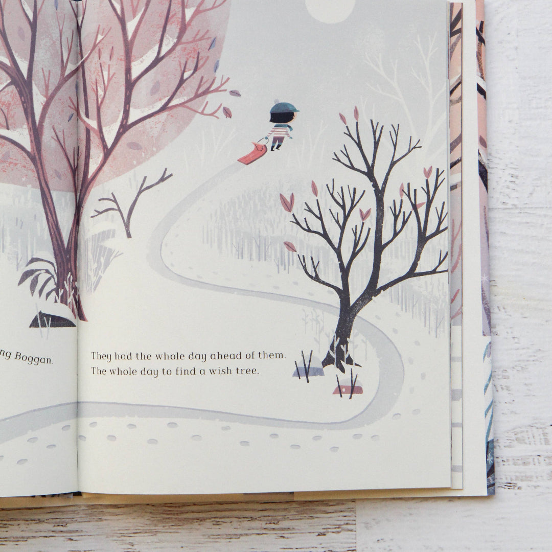 Open book with illustrated pages on a wooden surface