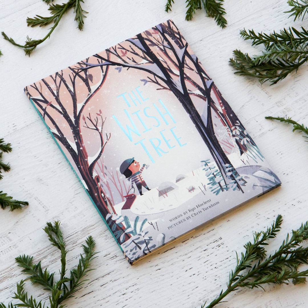 Book titled 'The Winter Tree' on a white surface with greenery