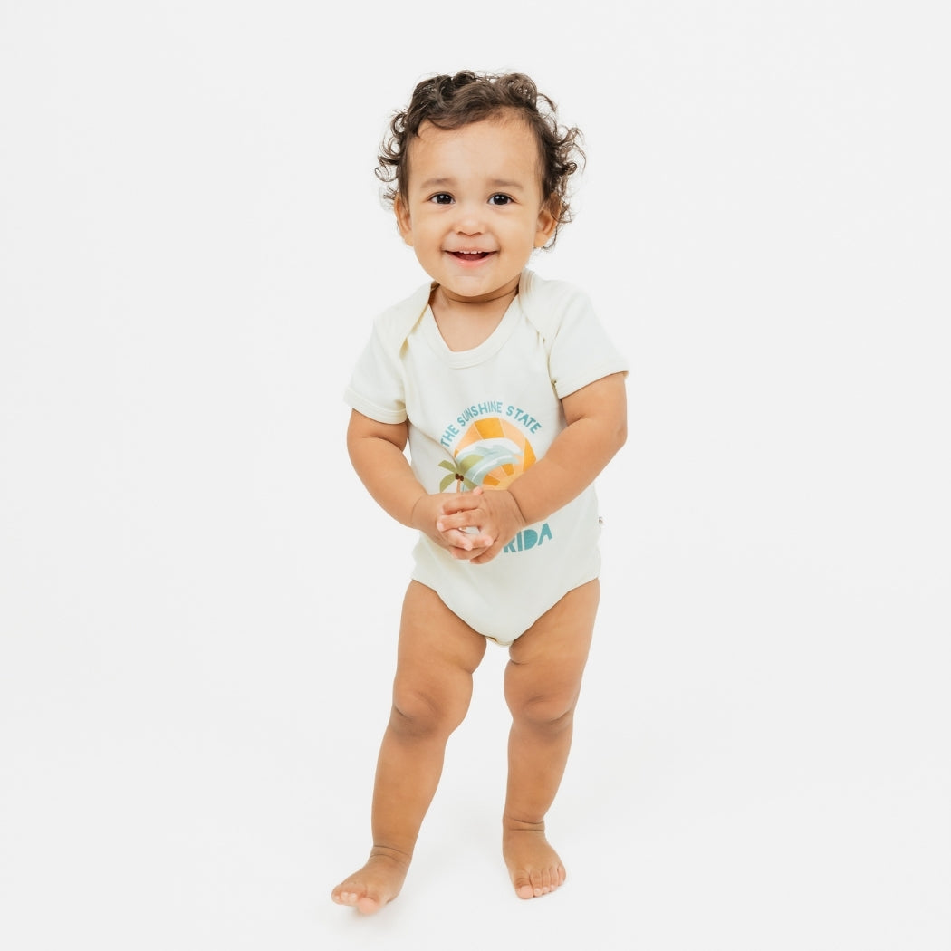 Florida Sunshine State baby onesie – soft & stretchy 100% cotton with unique vintage-inspired print, snap bottom, and fold-over shoulders for easy dressing.
