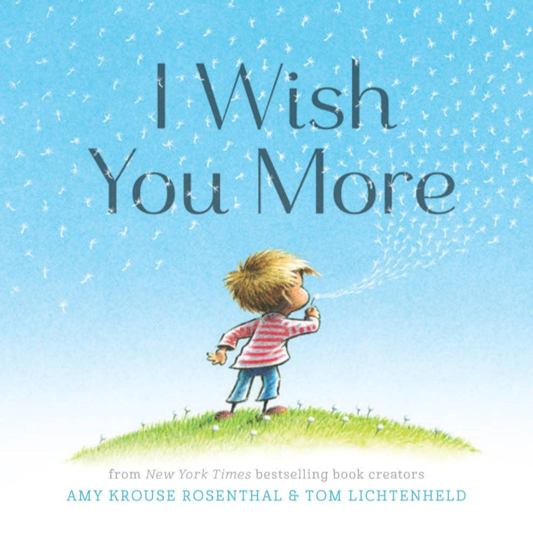 a hardcover book called I wish you more. There is a little boy blowing on a daffodil on the cover
