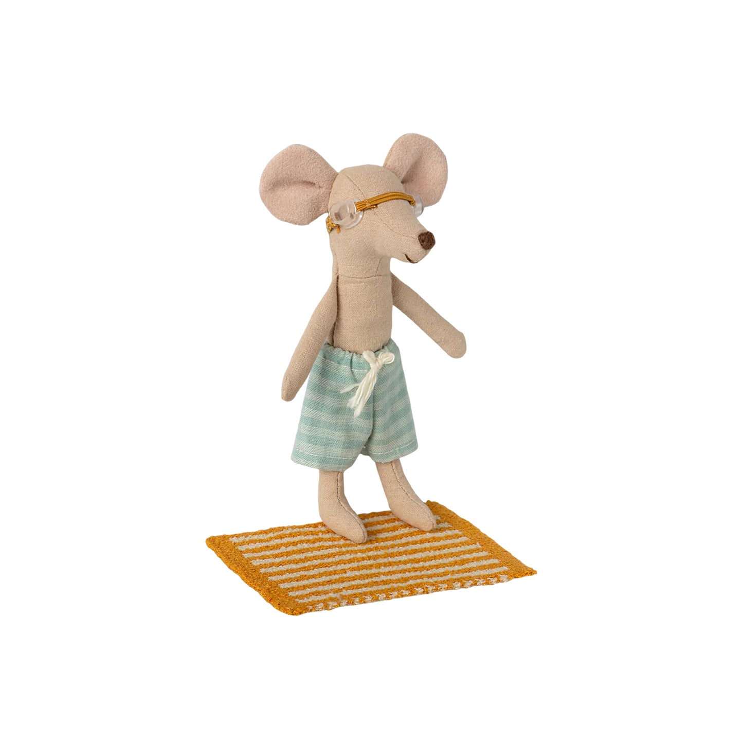 Stuffed mouse toy with glasses and shorts on a small rug against a white background