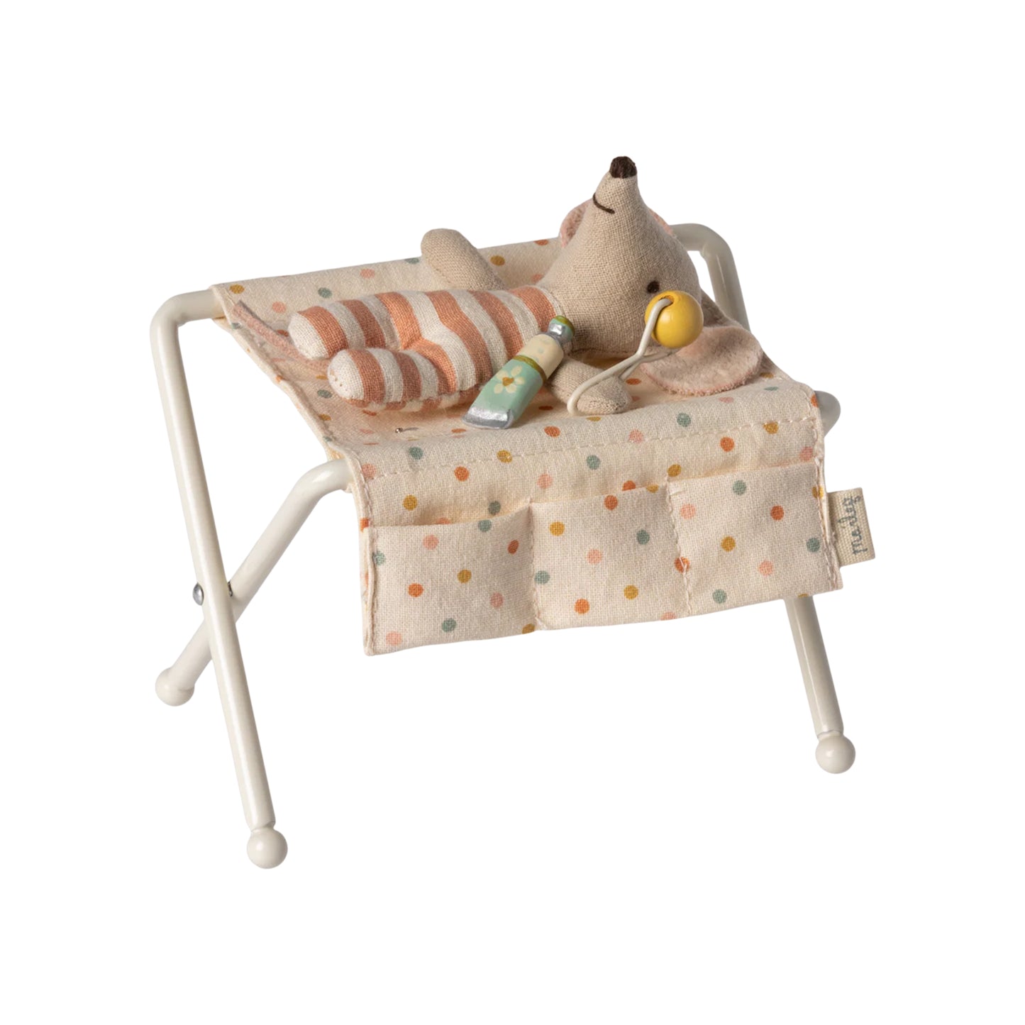 Toy bed with a plush animal and toys on a white background