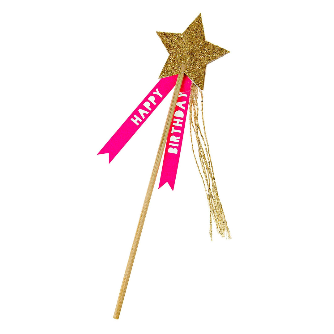 Gold star-shaped birthday cake topper with a pink ribbon on a white background