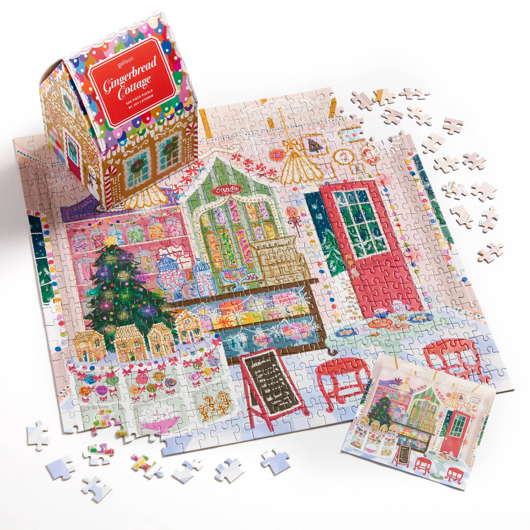 Gingerbread Cottage puzzle with pieces scattered on a white background