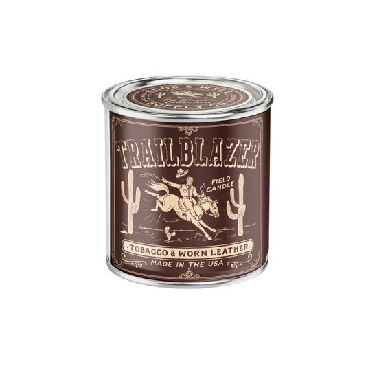 Trailblazer candle in a brown can with a horse and cactus design on a white background