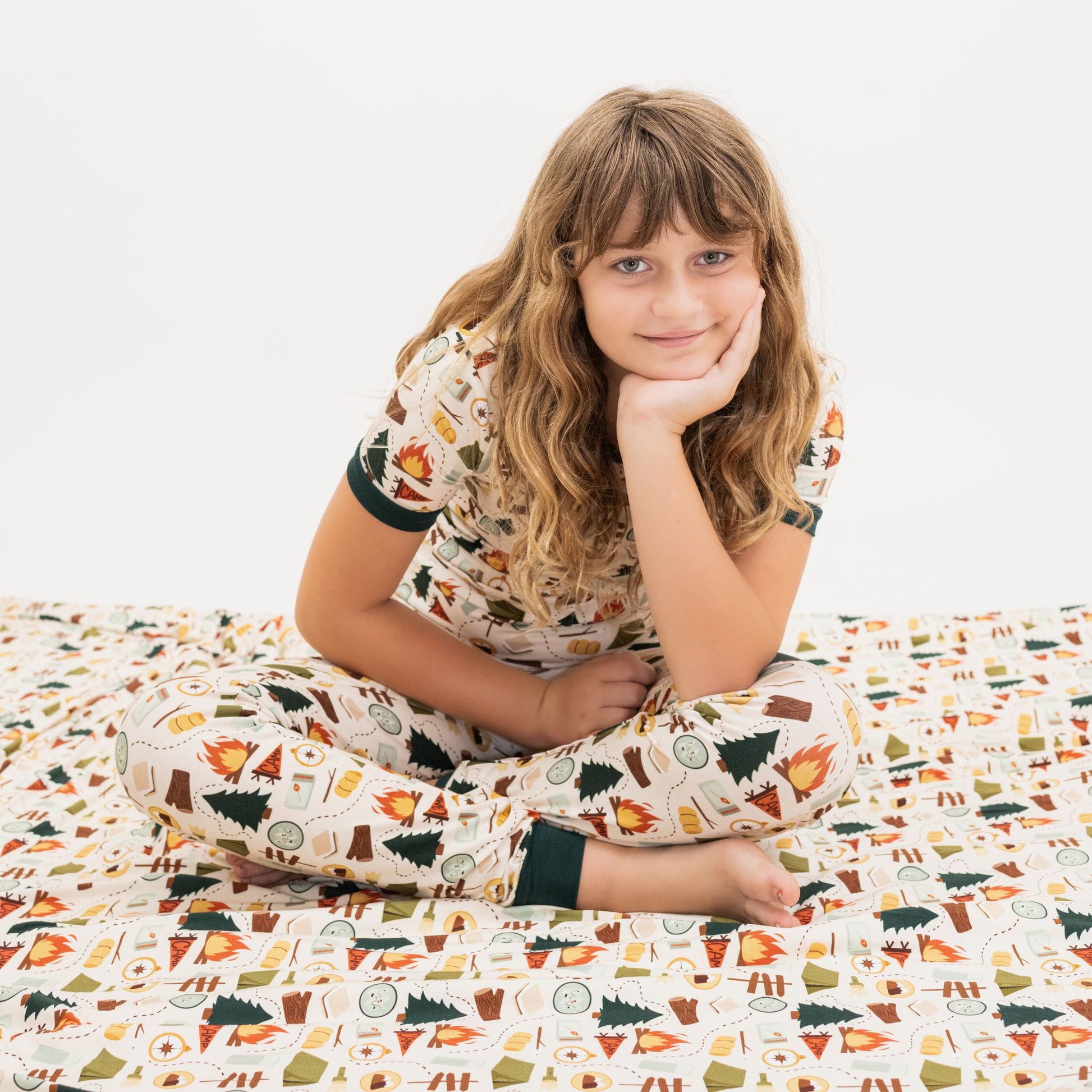 Flat lay of Camp Emerson bamboo fleece throw blanket, twin size with camping design.