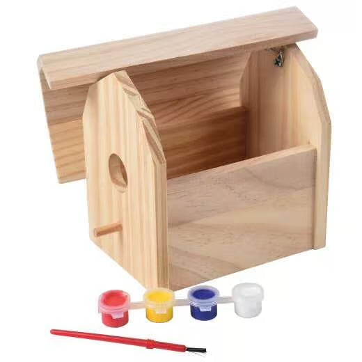 Wooden birdhouse with primary color paints and a paint brush from US Toy Company