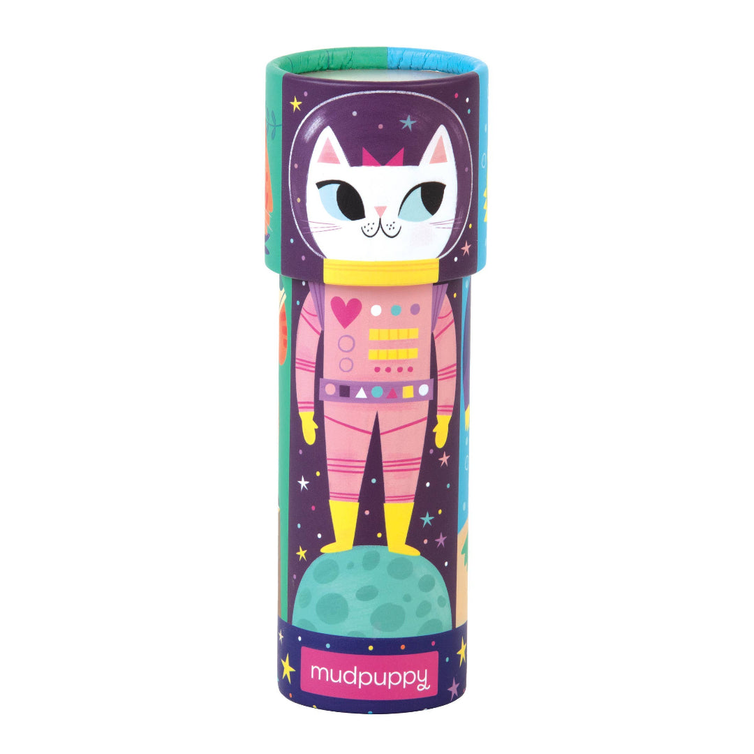 Colorful cylindrical toy packaging with a cat astronaut design on a white background, featuring the brand 'Mudpuppy'.