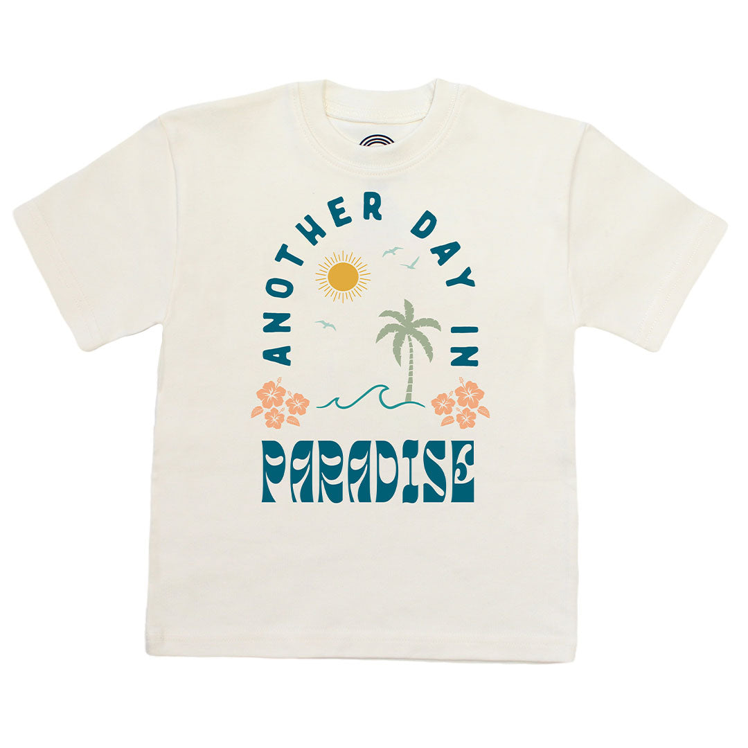 White t-shirt with 'Another Day in Paradise' design featuring palm trees and flowers on a white background