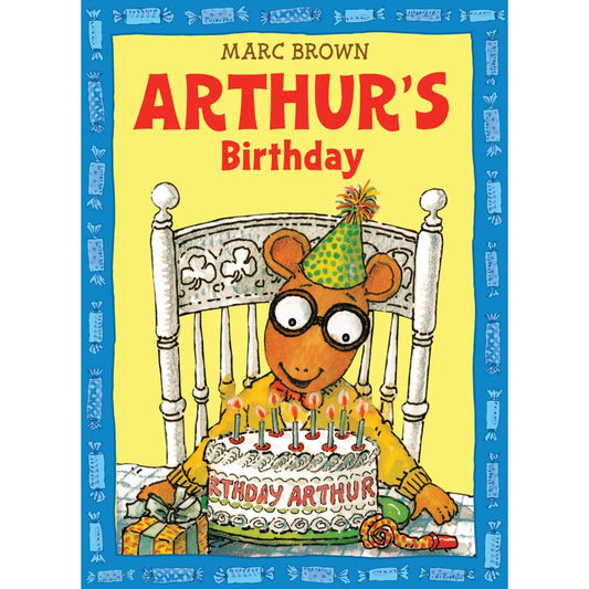 arthur sitting in front of his birthday cake waiting to blow out the candles