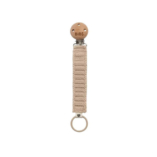 Natural woven pacifier clip with wooden ring on a white background