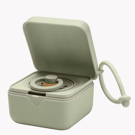 A Sage green hard plastic case with attachable loop that holds a pacifier from the company BIBS