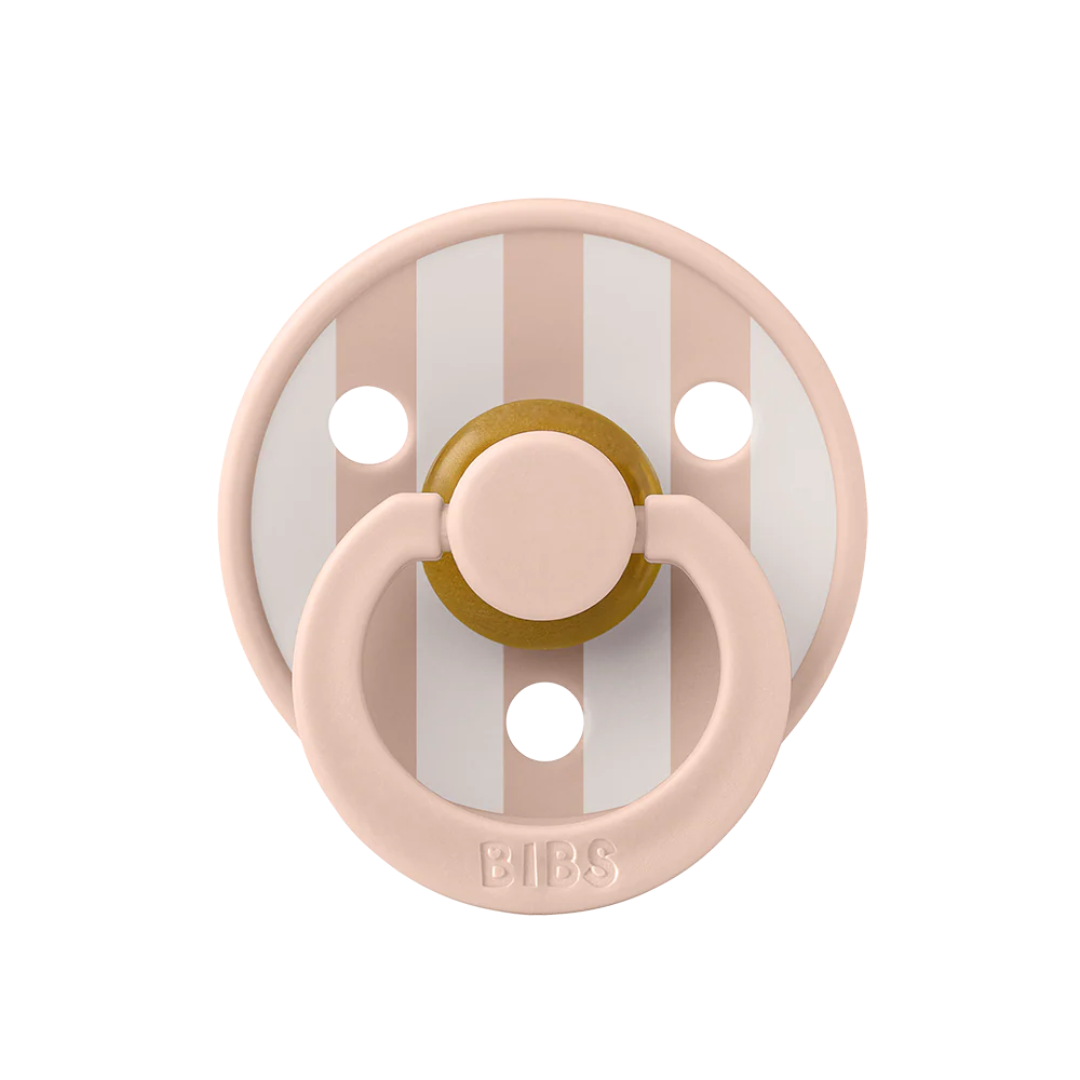 blush and white colored baby pacifier