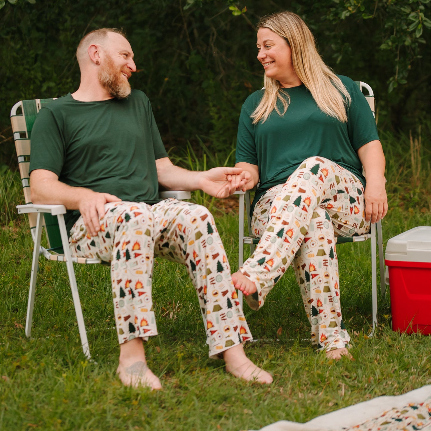 Man and woman sitting outdoors in matching Camp Emerson bamboo lounge pants.