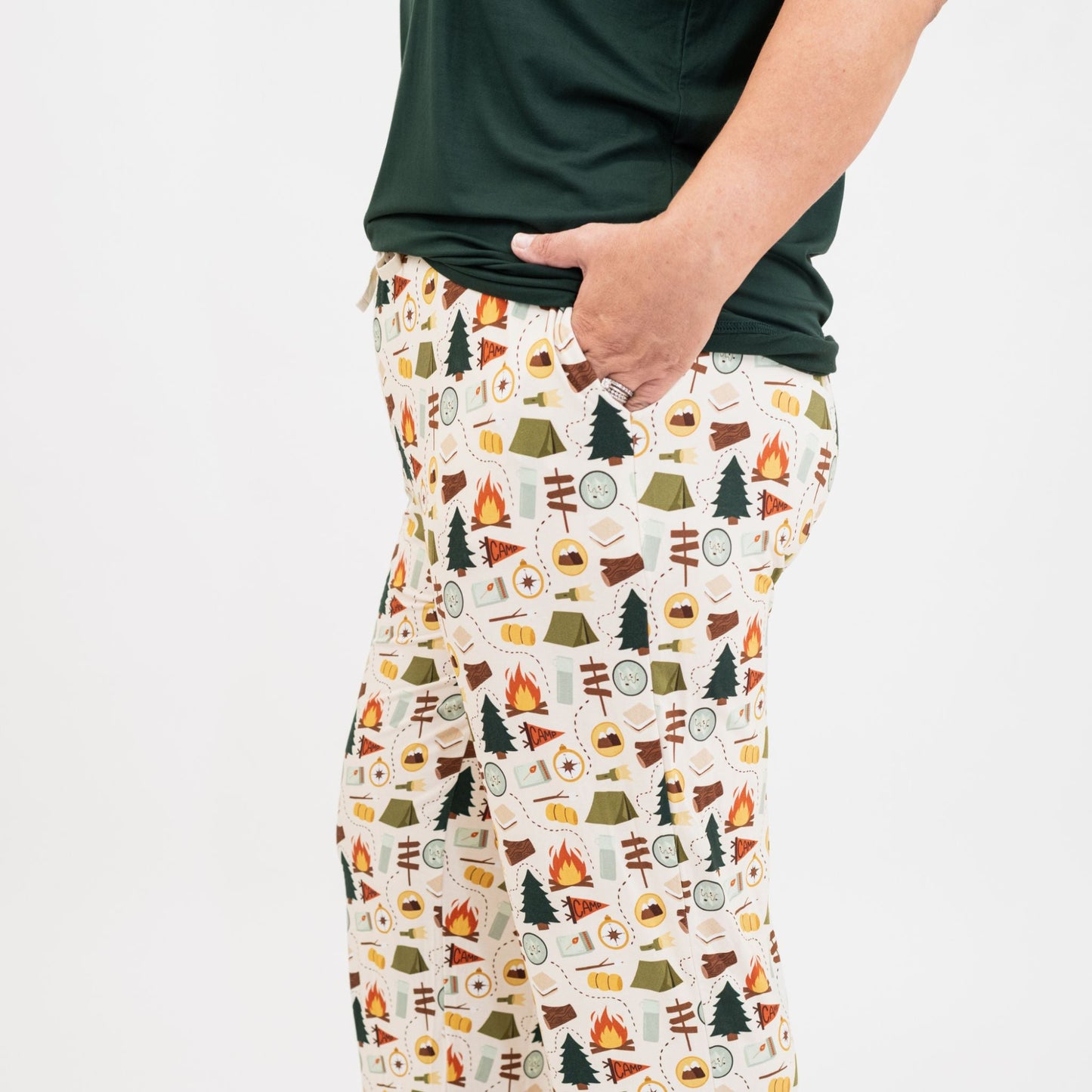 Close up on Camp Emerson Bamboo Pajama pants with camping pattern worn by a person on a white background