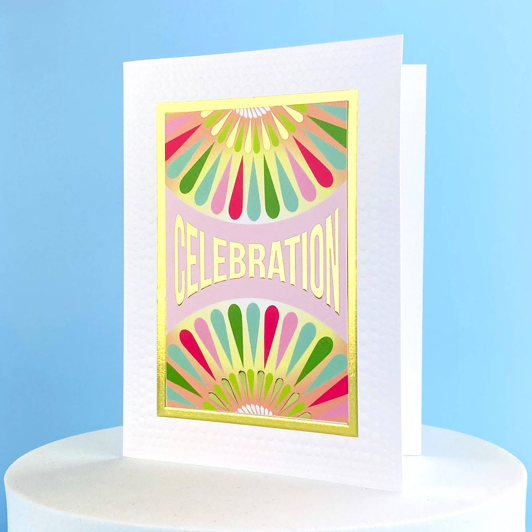Greeting card that says Celebration on the front and has multi colored designs on it