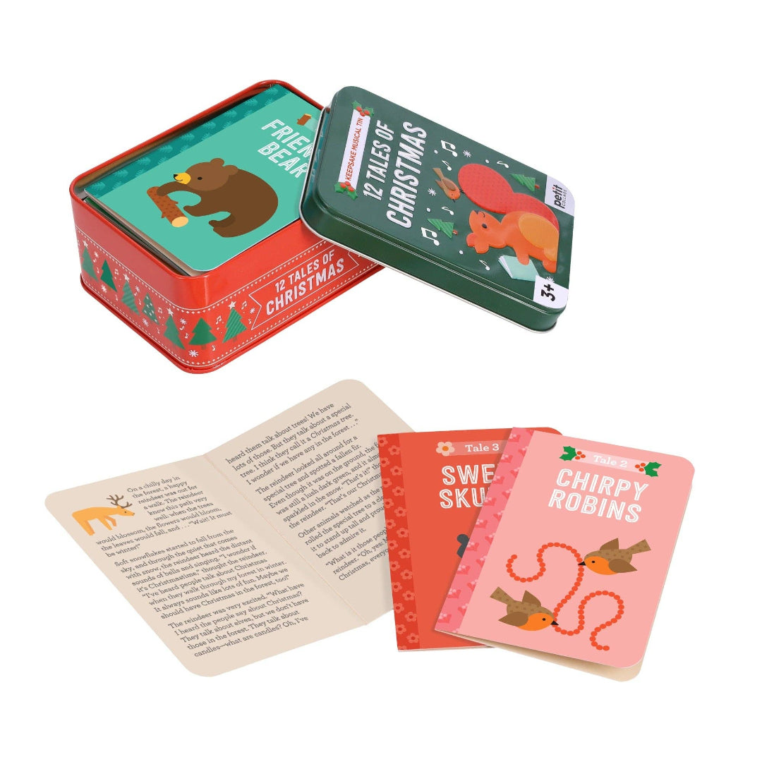 Set of Christmas-themed cards in a tin box with illustrations and text.