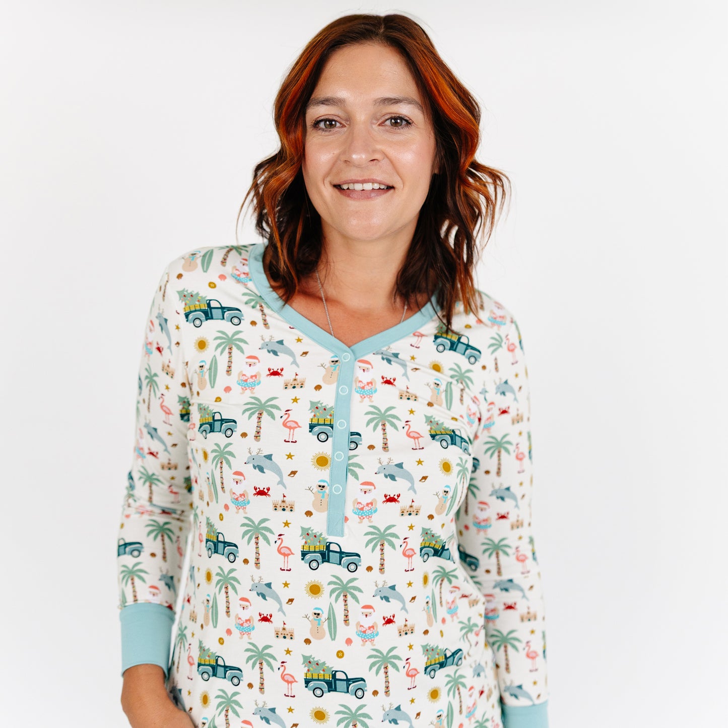 Woman wearing a patterned pajama top with a white background