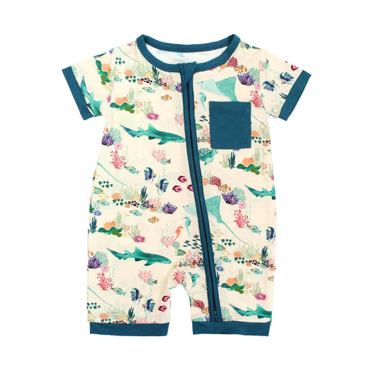 Emerson and Friends Coral Reef Bamboo Baby Shortie Romper, a soft and breathable summer outfit featuring an ocean-inspired print with sharks, sea turtles, and coral, designed for all-day comfort with an easy zip closure.