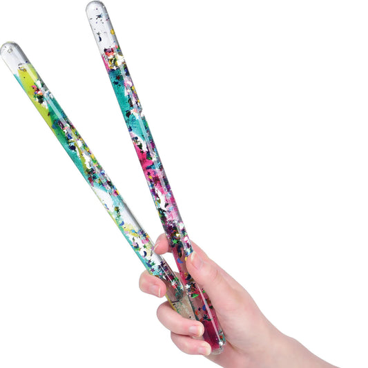 a glitter wand toy with spirals inside so when you flip it over the glitter falls in a spiral pattern