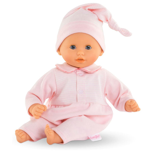 Baby doll in pink outfit and hat on a white background
