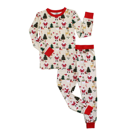 Flat lay of Cozy Christmas bamboo kids pajamas with red cuffs and festive holiday print featuring Santa, reindeer, and trees.
