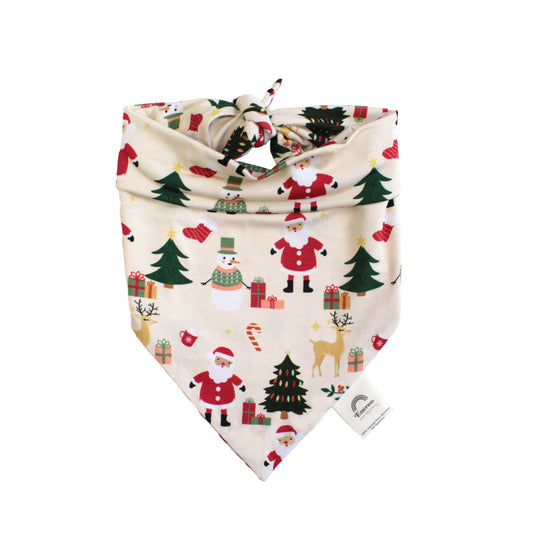 Flat lay of Cozy Christmas bamboo pet bandana featuring festive Santa, tree, and gift print on buttery soft fabric.