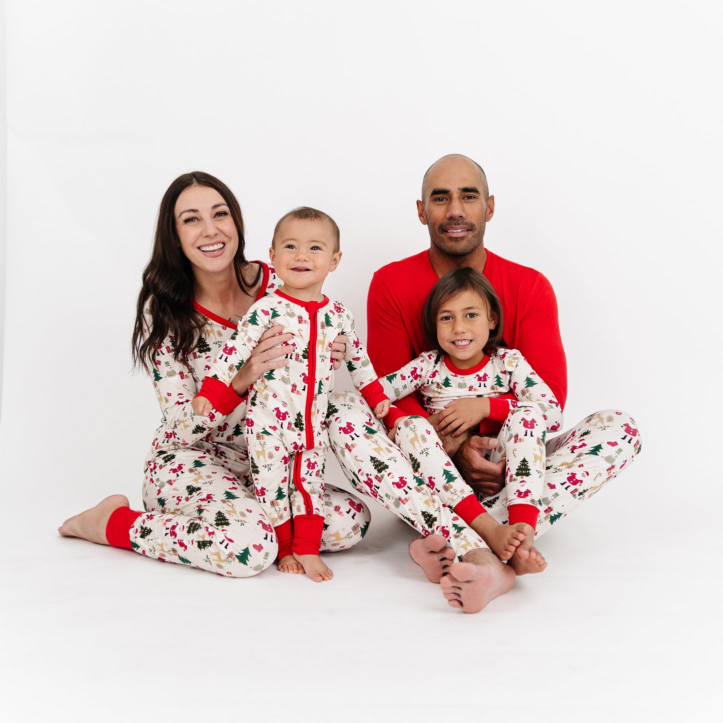 Family poses together in matching Cozy Christmas bamboo pajamas, featuring soft women’s jogger pants perfect for lounging.