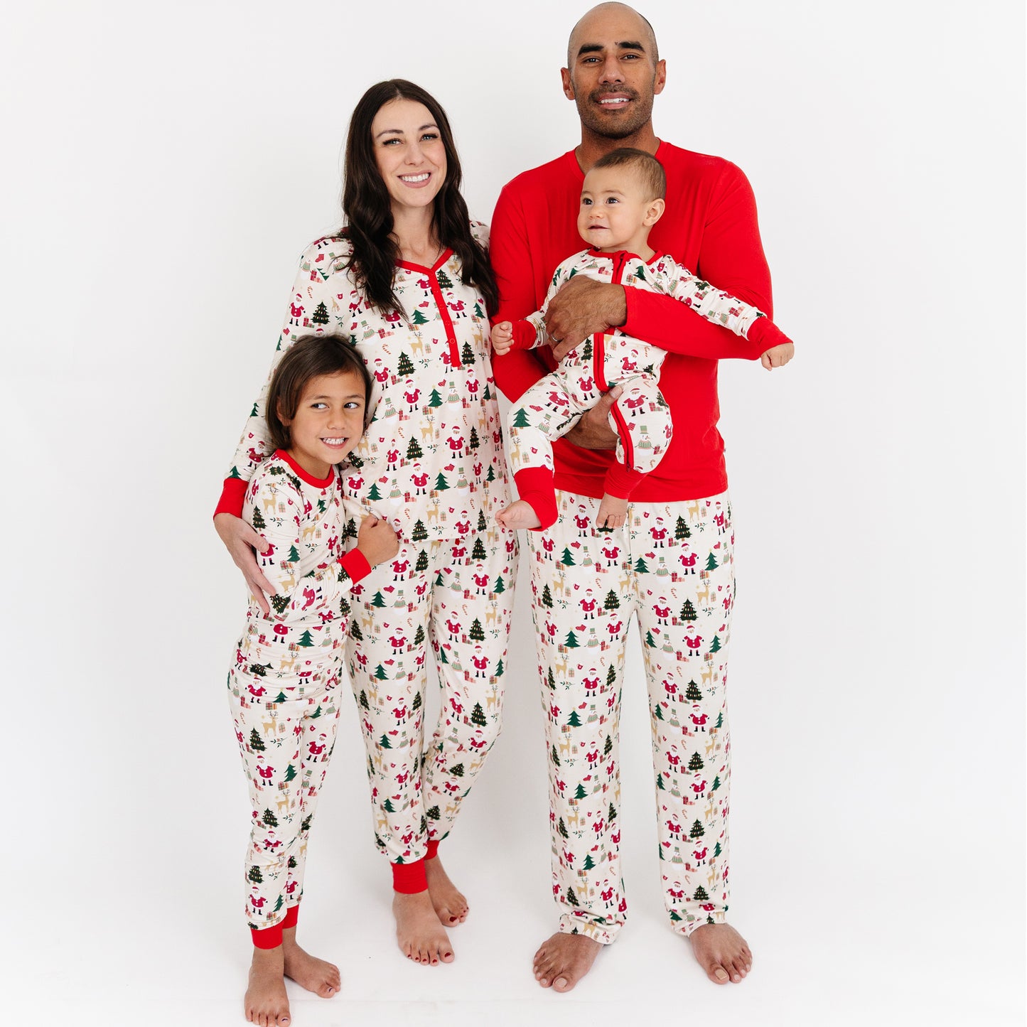 Family poses together in matching Cozy Christmas bamboo pajamas, celebrating the holidays in cozy, festive style.