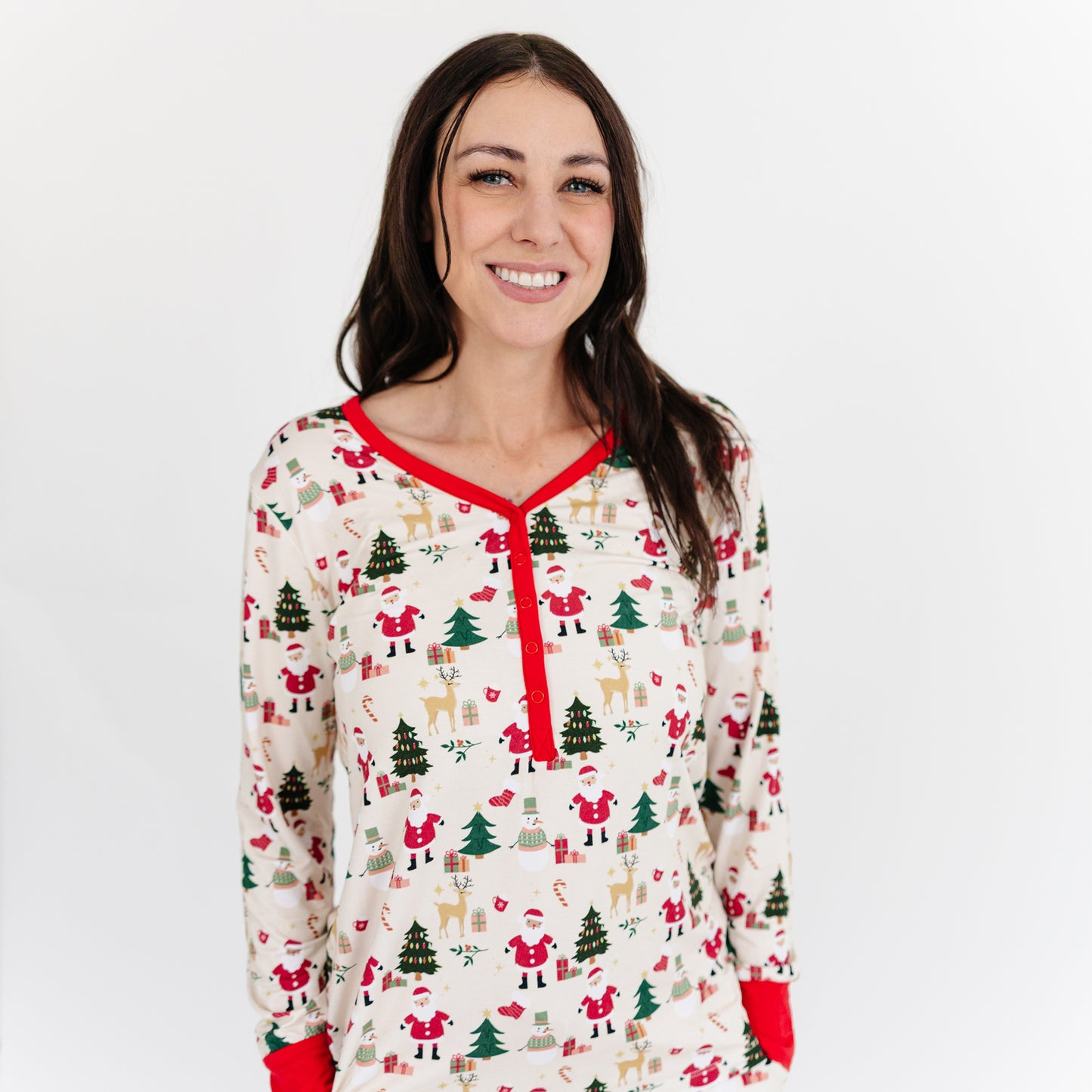 Woman wearing Cozy Christmas bamboo top with red trim poses for a portrait, showing festive style and cozy comfort.