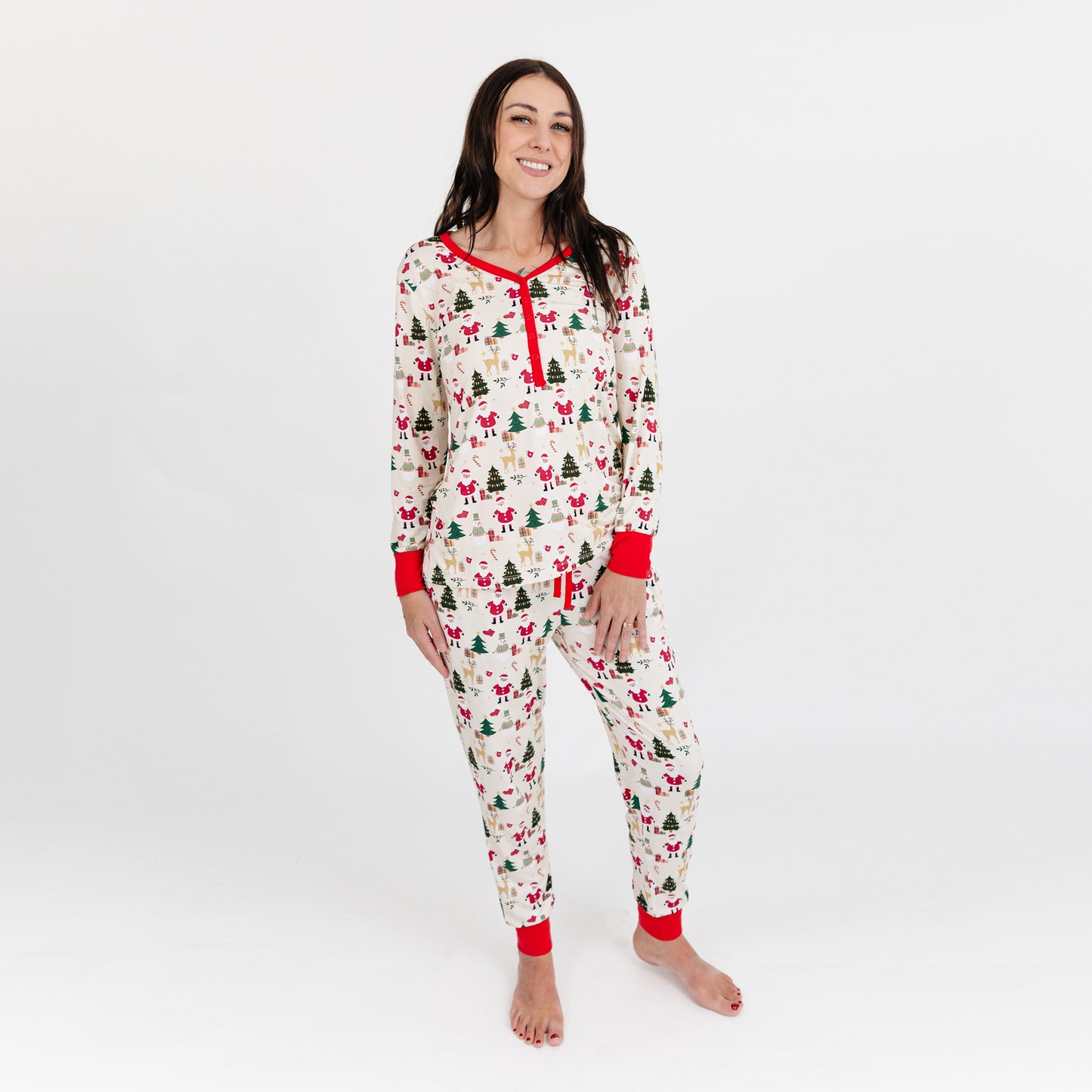 Woman stands wearing Cozy Christmas bamboo top and matching pajama pants, highlighting soft fabric and festive print.