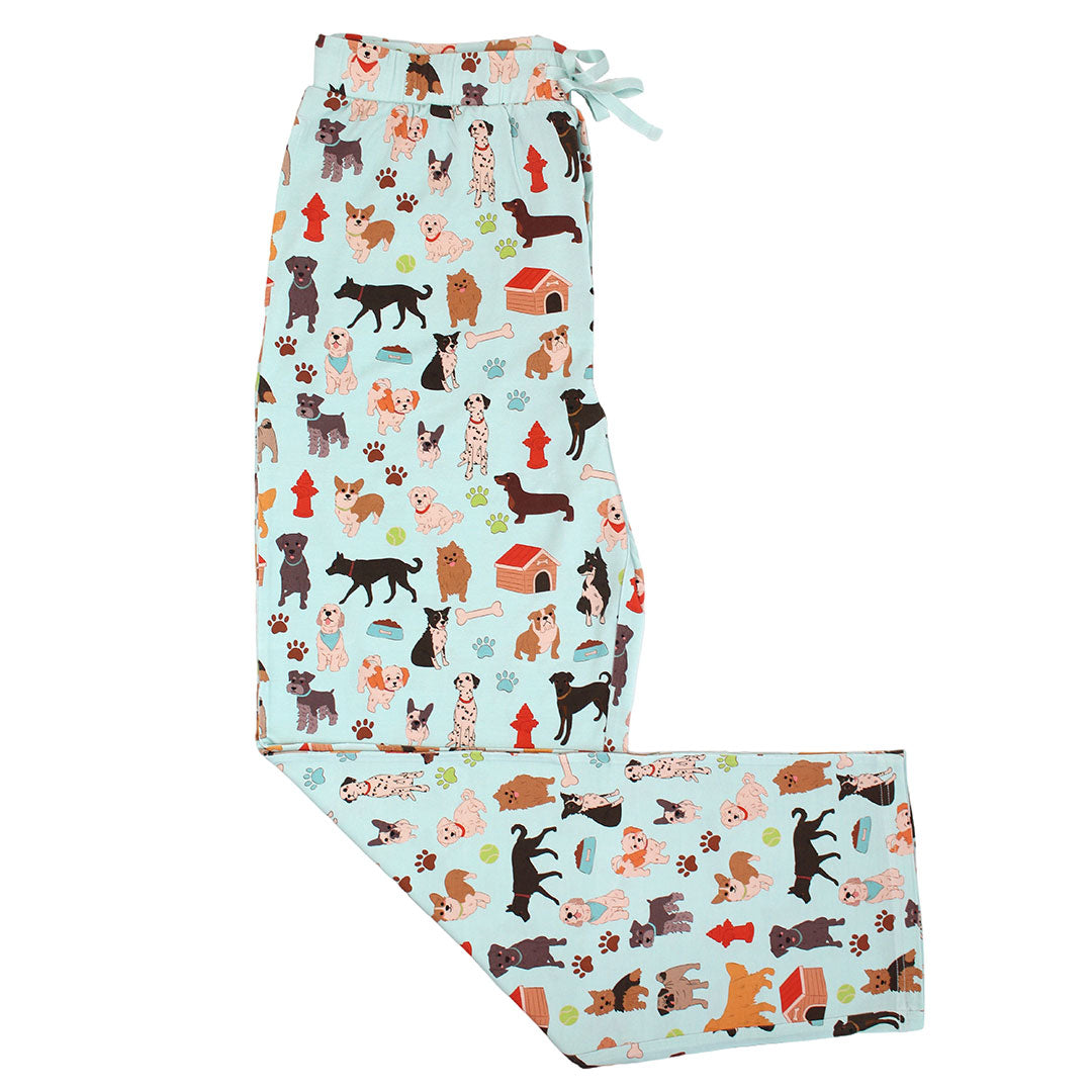 The "dogs bark" relaxed pants. the "dogs bark" print is a mix of various types of dogs, dog houses, dog bones, paw prints, dog food, and tennis balls scattered around a light blue background.