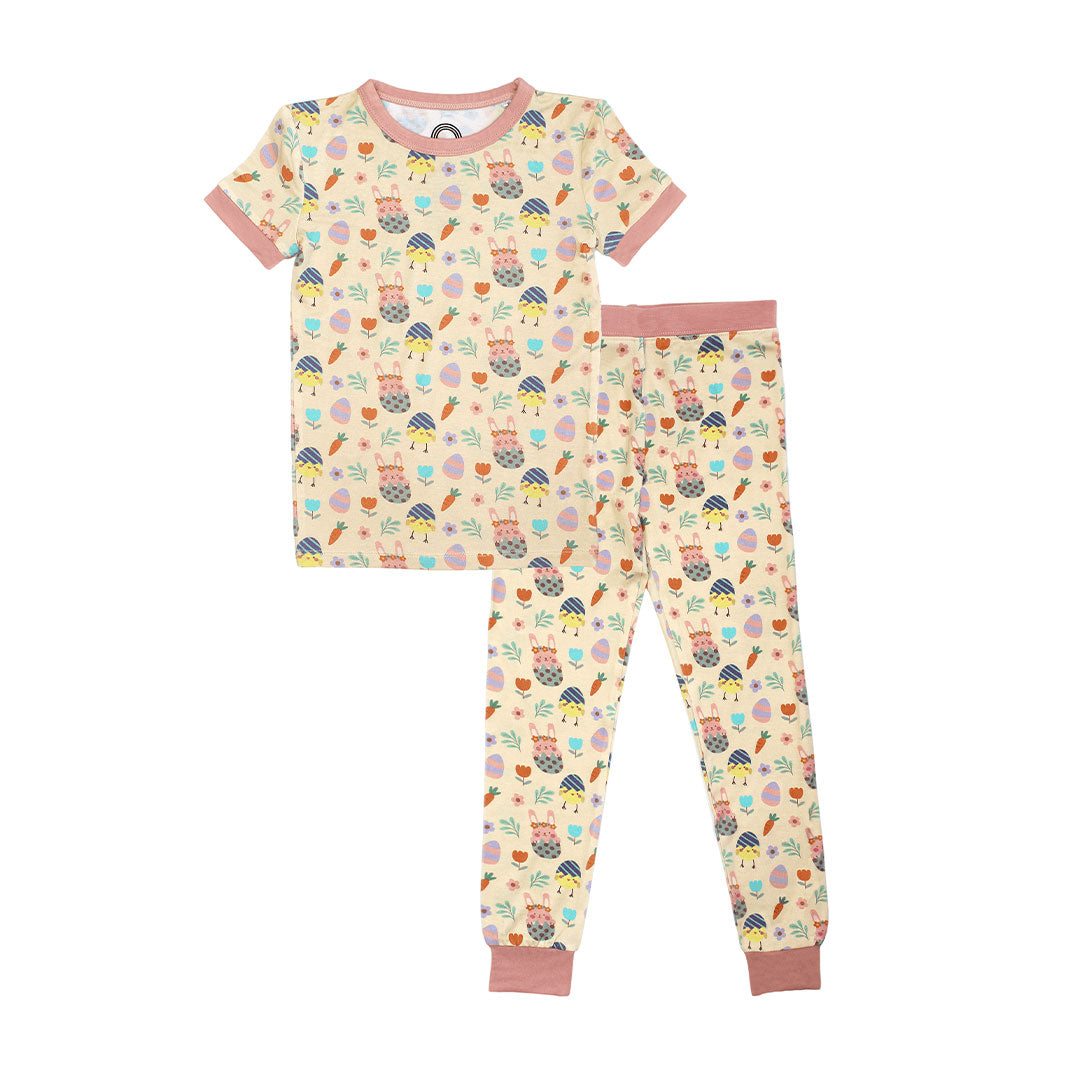 the "egg hunt" matching pajama set. the "egg hunt" print is a easter theme. the colors are pastel. you can find flowers, carrots, easter bunnies in easter eggs, and chicks who have half an easter egg on their head.