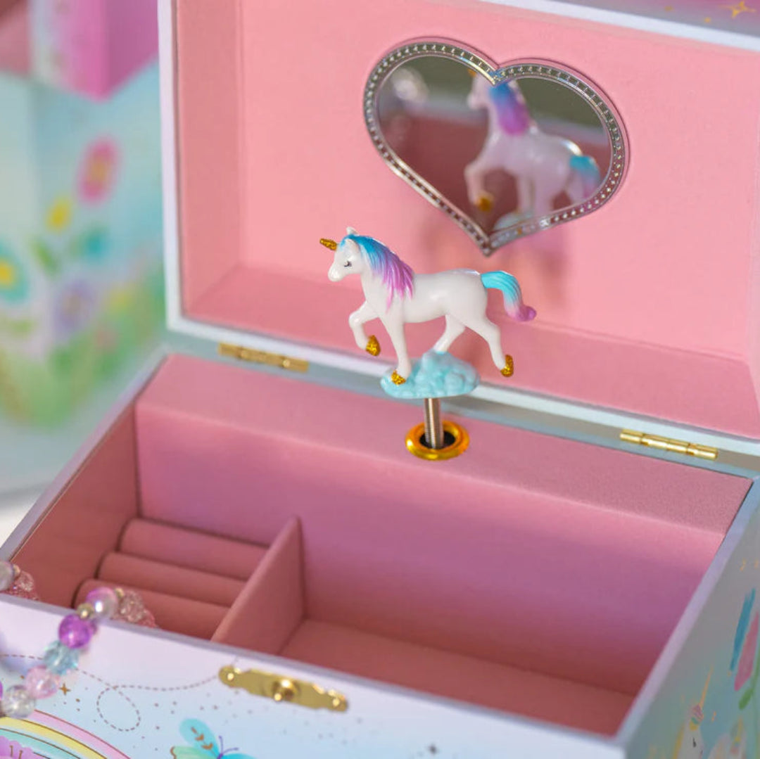 a jewelry box thats pink inside and has a unicorn that spins in the middle and a heart shaped mirror on the back