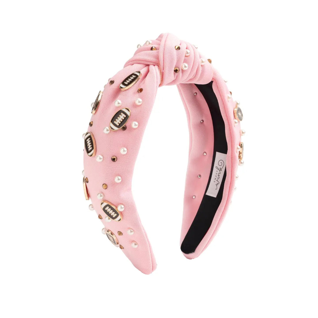 pink headband with little footballs on it