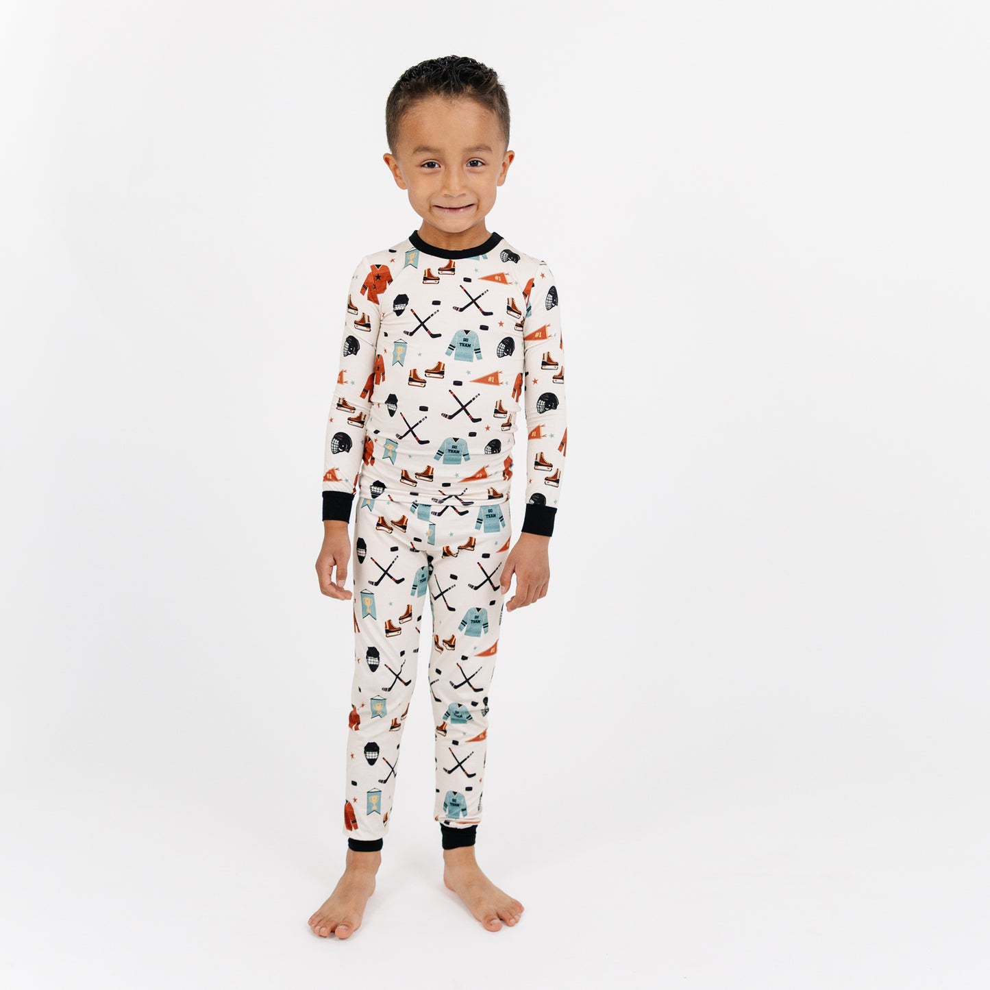 Child wearing a patterned pajama set on a white background