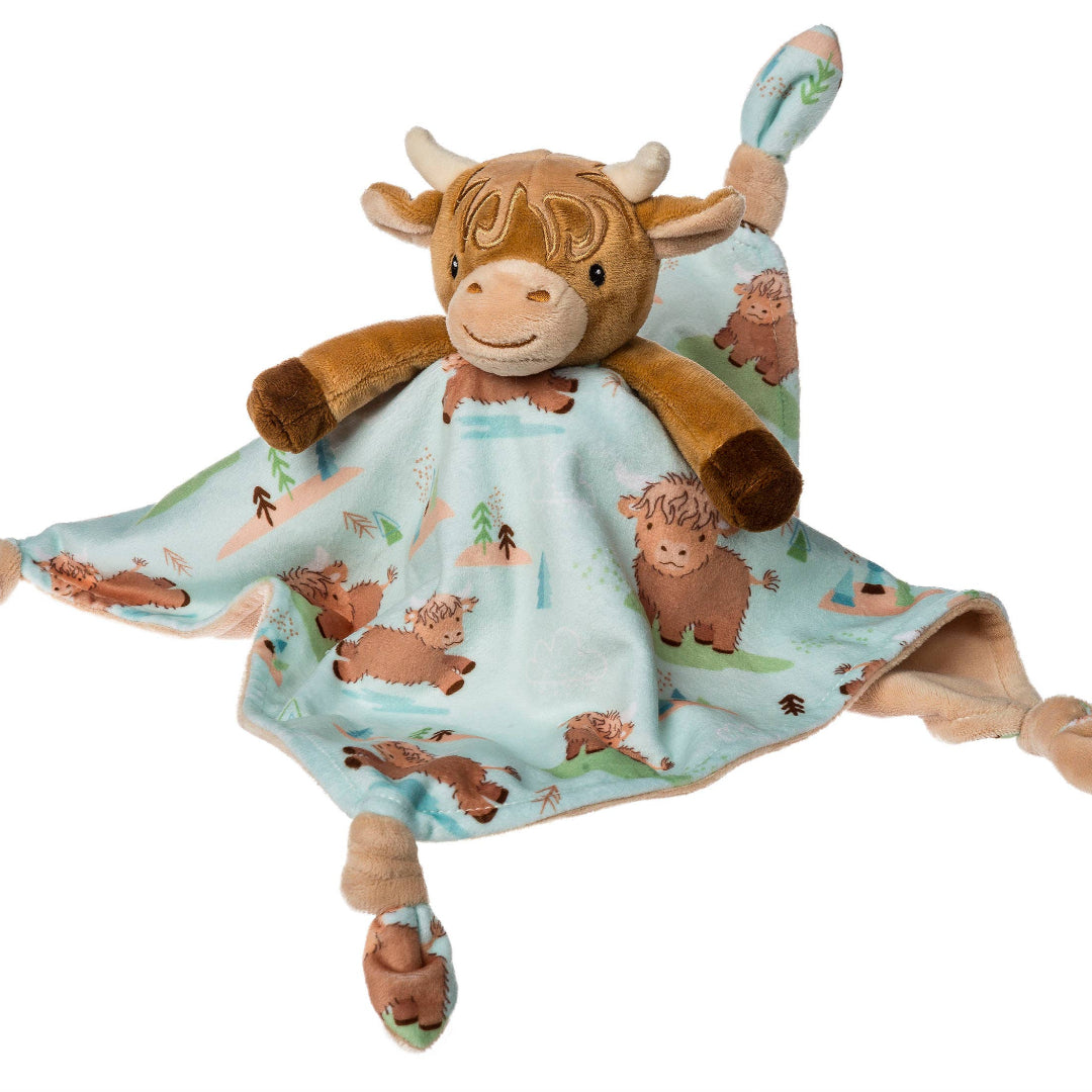 hyland cow plush attached to a tiny baby blanket