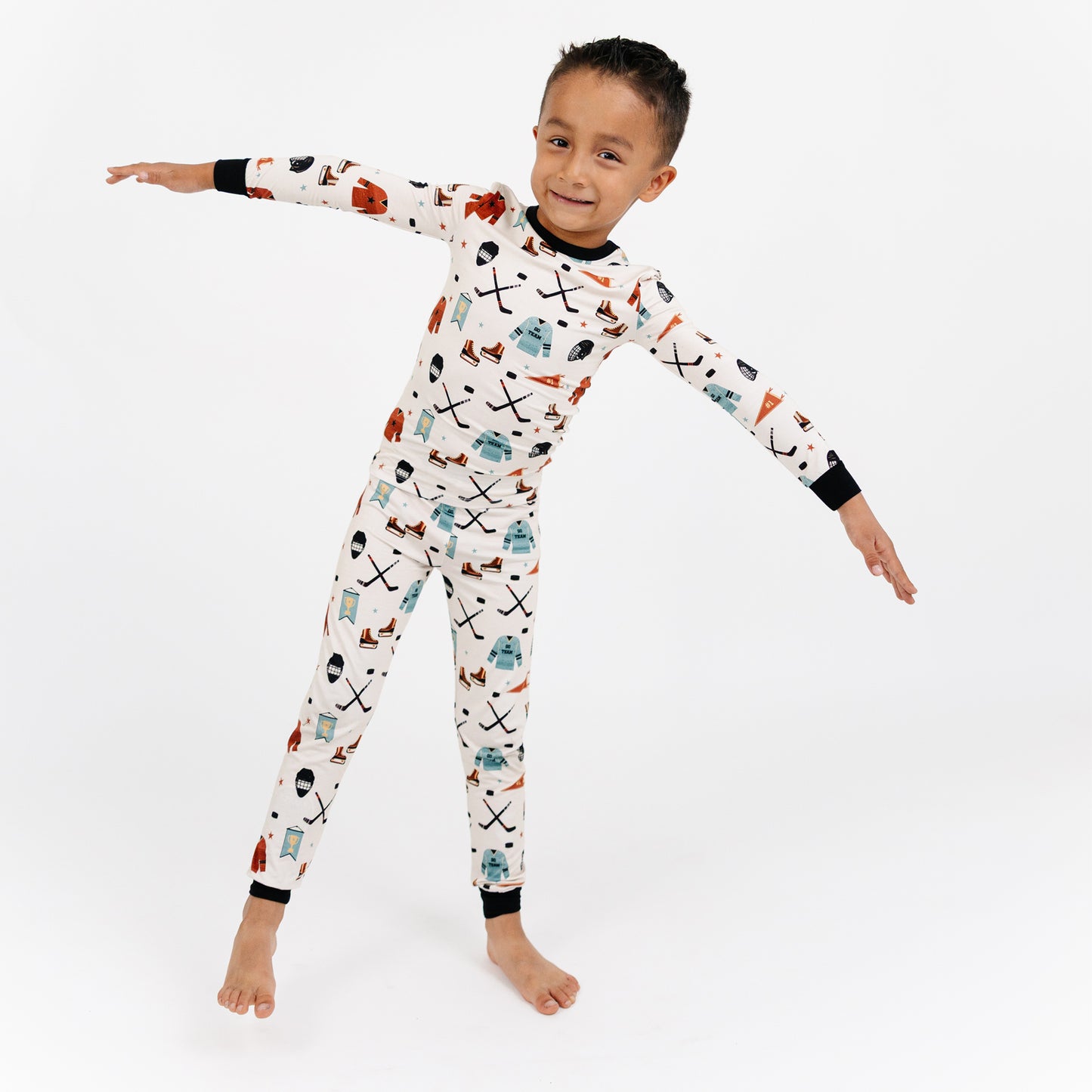 Child wearing a patterned onesie on a white background