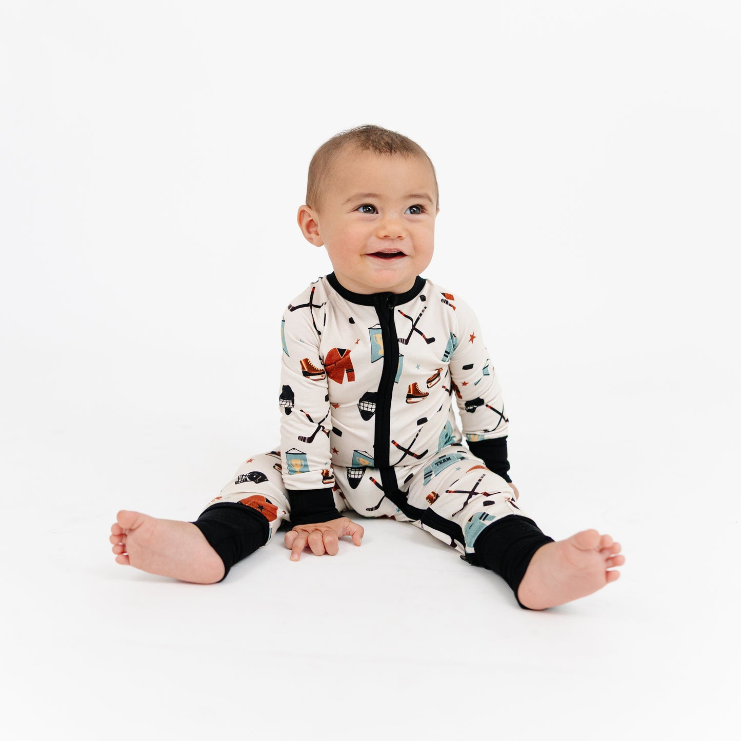 Baby wearing a patterned onesie on a white background