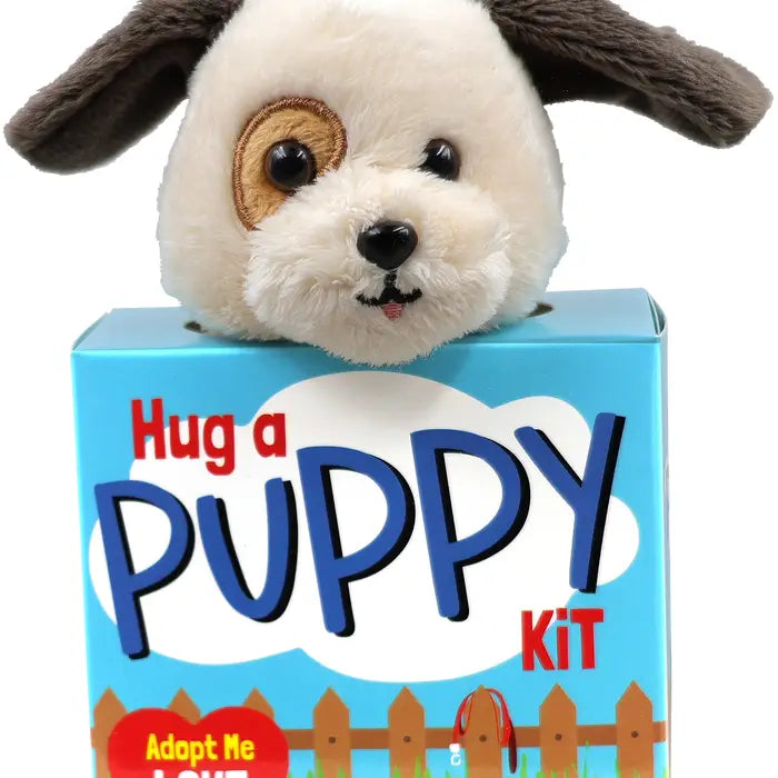 stuffed puppy toy inside a box with a puppy huggers guide included