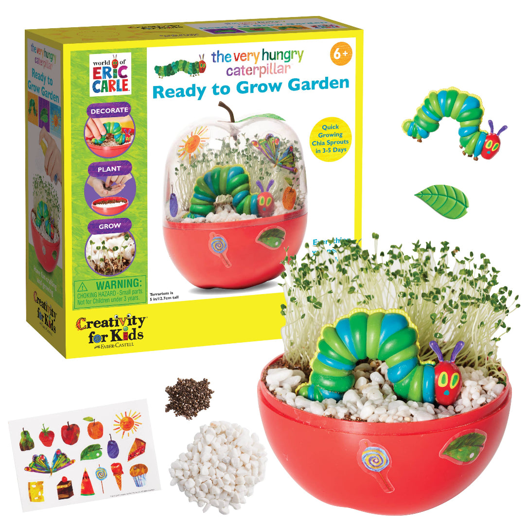 The Very Hungry Caterpillar themed chia seed grow kit in a red apple-shaped terrarium with decorations, seeds, and white stones.