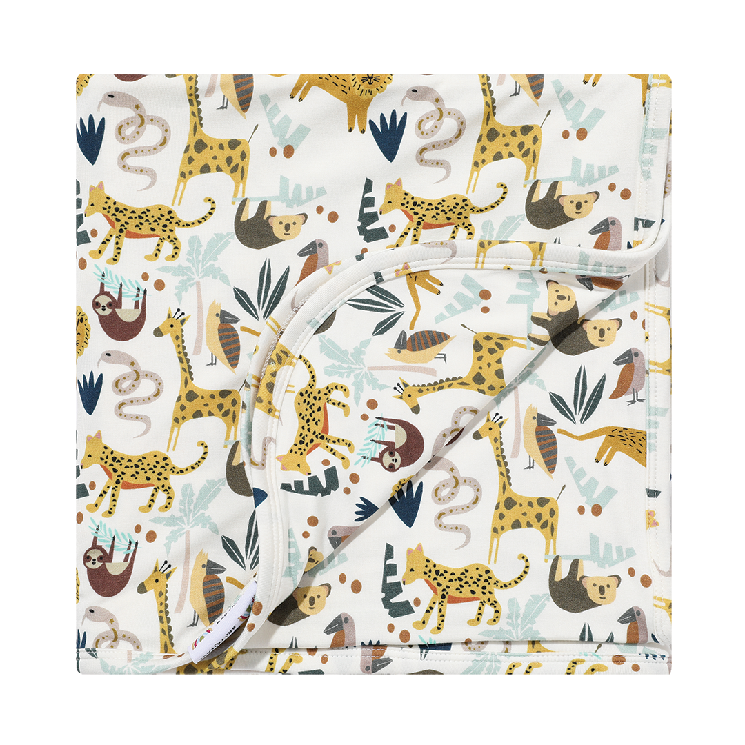 the "jungle friends" bamboo blanket. the "jungle friends" print is a mix of jungle animals that include giraffes, lions, cheetahs, sloths, snakes, and forest plants.