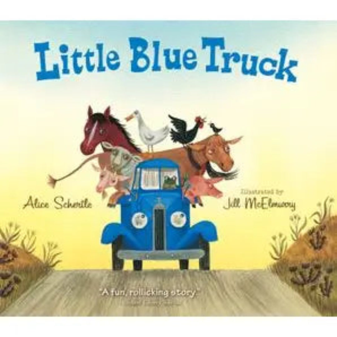 a blue truck driving on a road with farm animals in the bed of the truck