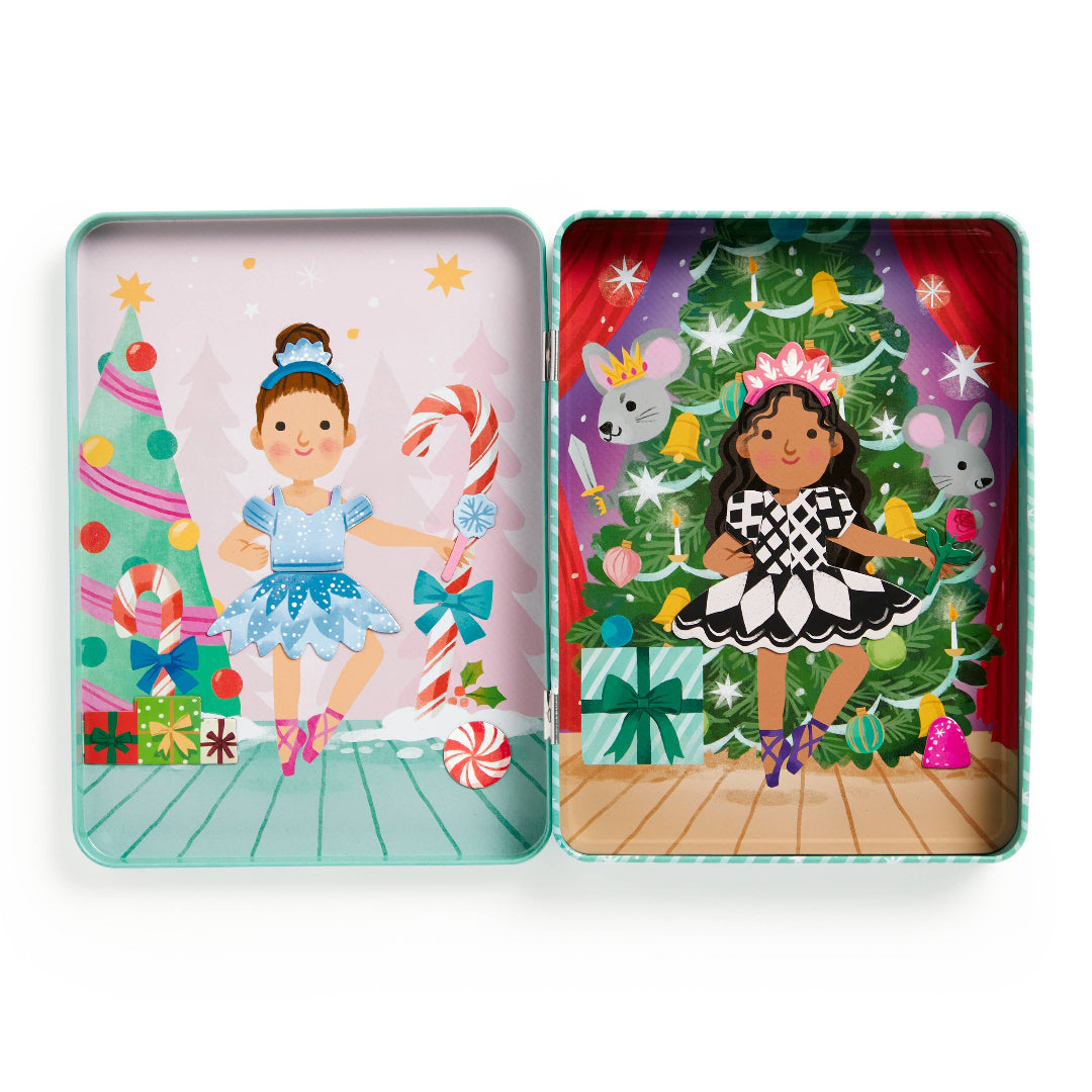 Two colorful tins featuring illustrations of girls in festive outfits with Christmas trees and candy.