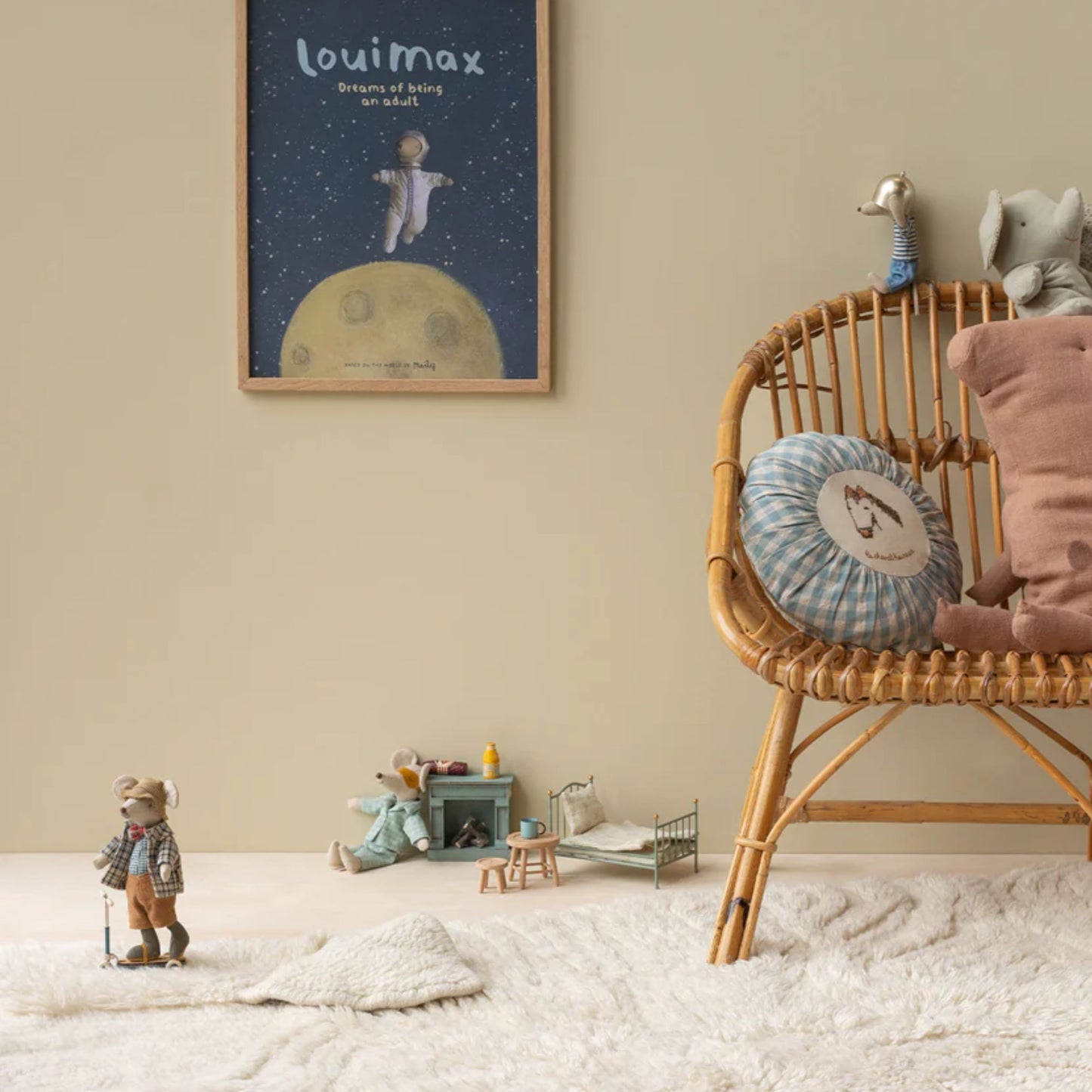 Children's room with wicker chair, toys, and framed artwork on a beige wall.