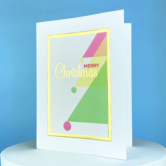 pink, green, and gold greeting card that says Merry Christmas