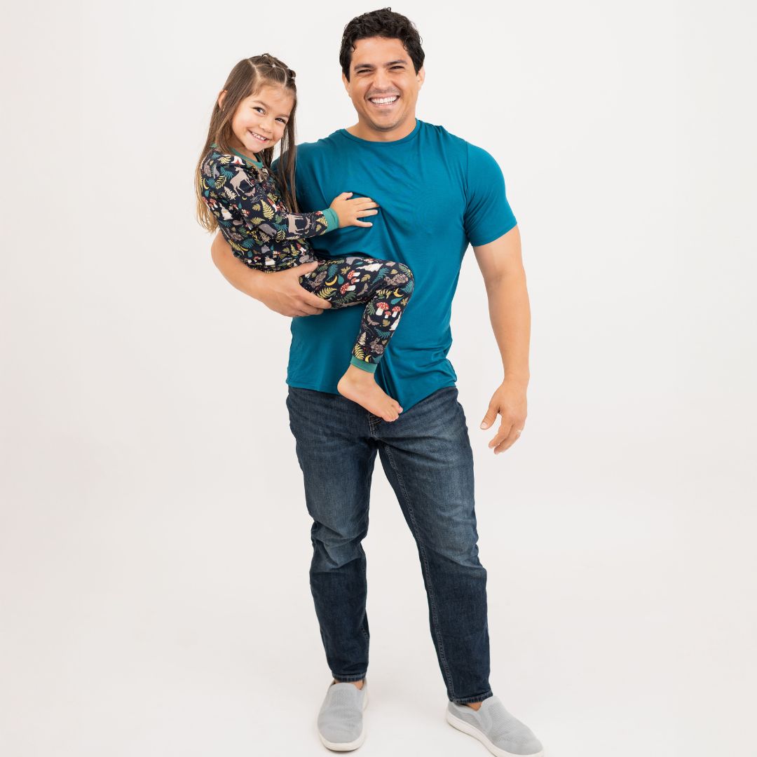 Man holding a child on a plain background